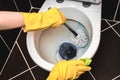 Woman is cleaning toilet bowl using brush Royalty Free Stock Photo