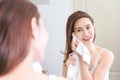 Woman cleaning washing on her face with clean water in bathroom. Royalty Free Stock Photo
