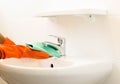 Woman cleaning water tap