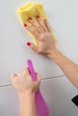 Woman cleaning white surface