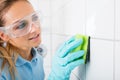 Woman Cleaning The White Tile Of The Wall Royalty Free Stock Photo