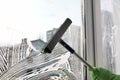 Woman cleaning window with squeegee, closeup Royalty Free Stock Photo