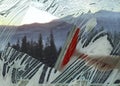 Woman cleaning window with squeegee, closeup. View through clear glass on picturesque mountains Royalty Free Stock Photo