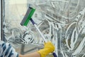 Woman cleaning window with squeegee at home, closeup. Space for text Royalty Free Stock Photo