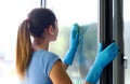 Woman cleaning windows at home Royalty Free Stock Photo