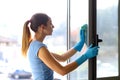 Woman cleaning windows at home Royalty Free Stock Photo