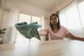 Woman cleaning and wiping the table with microfiber cloth in the living room. Woman doing chores at home. Royalty Free Stock Photo