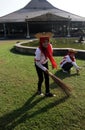 Woman cleaning the yard around the temple Mangkunegaran central java Indonesia