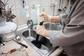 a woman cleans a clogged sink with a plunger Royalty Free Stock Photo