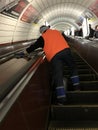 A woman cleans the escalator of the Kiev Metro Kyiv Metro