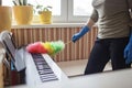 Woman cleans home  wipes dust from the piano and dreams about music  authentic inner life Royalty Free Stock Photo