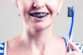 Woman cleans her teeth with charcoal toothpaste. People and healthcare concept