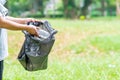 Woman cleans up by picking up plastic bottles in garden. Concept of protecting the environment, saving the world, recycling,
