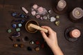 Woman cleansing healing chakra crystals with tibetan singing bowl. Rituals with gemstones for wellness Royalty Free Stock Photo