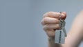 Woman clenching keychain with freedom word in fist, discrimination protest