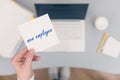 Woman clerk sitting holding note paper sticker with new employee phrase. Business concept.