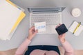 Woman clerk is sitting at office table holding note sticker with message call mum