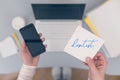 Woman clerk is sitting at office table holding note sticker with reminder dentist