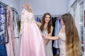 Woman client looking at dress in garment store Royalty Free Stock Photo