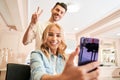 Woman client taking a selfie with a hair stylist