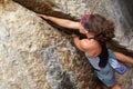 Woman, cliff and rock climbing strong exercise in mountains for adventure, fitness or extreme sport. Female person Royalty Free Stock Photo