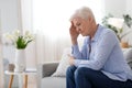 Woman Climax. Portrait Of Depressed Elderly Woman Sitting On Couch At Home