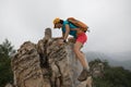woman climber climbing rock on the top of mountain Royalty Free Stock Photo