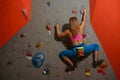 Woman Climber Practicing Rock-climbing in the Bouldering Gym. Extreme Sport and Indoor Climbing Concept Royalty Free Stock Photo