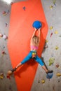 Woman Climber Practicing Rock-climbing in the Bouldering Gym. Extreme Sport and Indoor Climbing Concept Royalty Free Stock Photo