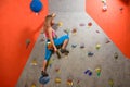 Woman Climber Practicing Rock-climbing in the Bouldering Gym. Extreme Sport and Indoor Climbing Concept Royalty Free Stock Photo