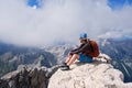 Woman climber sits on a rock at Triglav peak, Slovenia, on a Summer day. Royalty Free Stock Photo