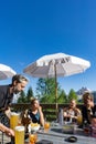 Woman climbers and their mountain guide relax in a bar with beer and chips after a hard climb in the Dolomites