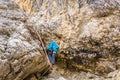 Woman climbing on metal ladder in via ferrata Royalty Free Stock Photo