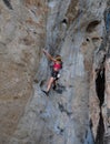 Woman climbing on the rock route summer