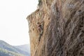 A woman is climbing a rock wall Royalty Free Stock Photo