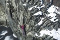 Woman climbing up basalt rocks, Iceland