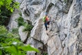 Woman climbing via ferrata Zimmereben, near Mayrhofen, Zillertal valley, Austria
