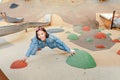 Woman climbing on a wall at urban children playground Royalty Free Stock Photo