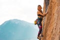 A woman climbs a rock