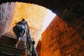 The woman climbs the steep stairs inside the Red Tower - the main fortification of the city Alanya, Turkey