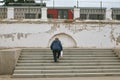 Woman climbs the steps to the train station