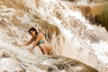 Woman climbs in a waterfall