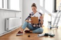 woman with clipboard sitting on floor at home Royalty Free Stock Photo