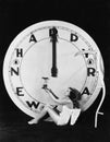 Woman with clock at midnight on New Years Eve Royalty Free Stock Photo