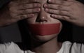 Woman close her eyes and wrapping mouth by adhesive tape. Concept freedom of speech, censorship, freedom of press and Royalty Free Stock Photo