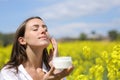 Woman applying moisturizer cream on cheek a sunny day Royalty Free Stock Photo