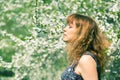 Woman with closed eyes smelling cherry blossoms Royalty Free Stock Photo