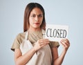 Woman, closed sign and entrepreneur in studio portrait for worry, angry or frustrated by background. Entrepreneurship