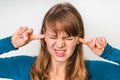 Woman closes ears with fingers to protect from loud noise Royalty Free Stock Photo