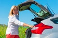 Woman closes the trunk of the car